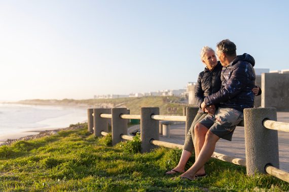 Side view senior couple beach